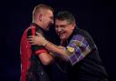 EXIT: Gary Anderson (right) congratulates Nathan Aspinall on his victory at the PDC World Championship at Alexandra Palace, London. Pic: PA Wire