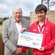 Alan Gloak, TS5C chairman, presenting a grant cheque to one of the charity's young athletes, Ronnie Wells