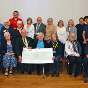 The cheques were presented on March 28 at the Berrow Village Hall