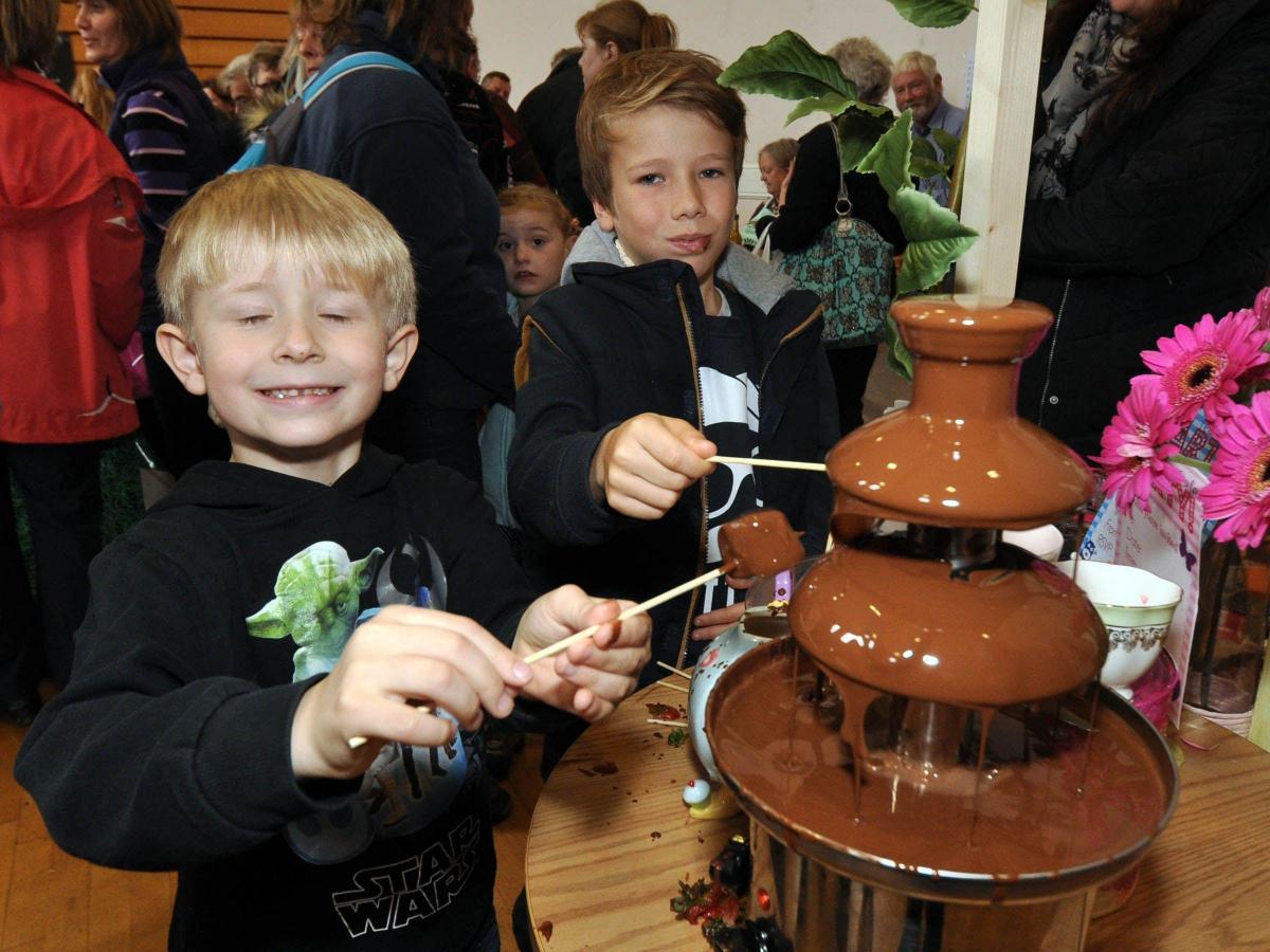 DANIEL Phillips and Jamie Roberts enjoying the Crafty
Cafe chocolate fountain. PHOTO: Mike Lang