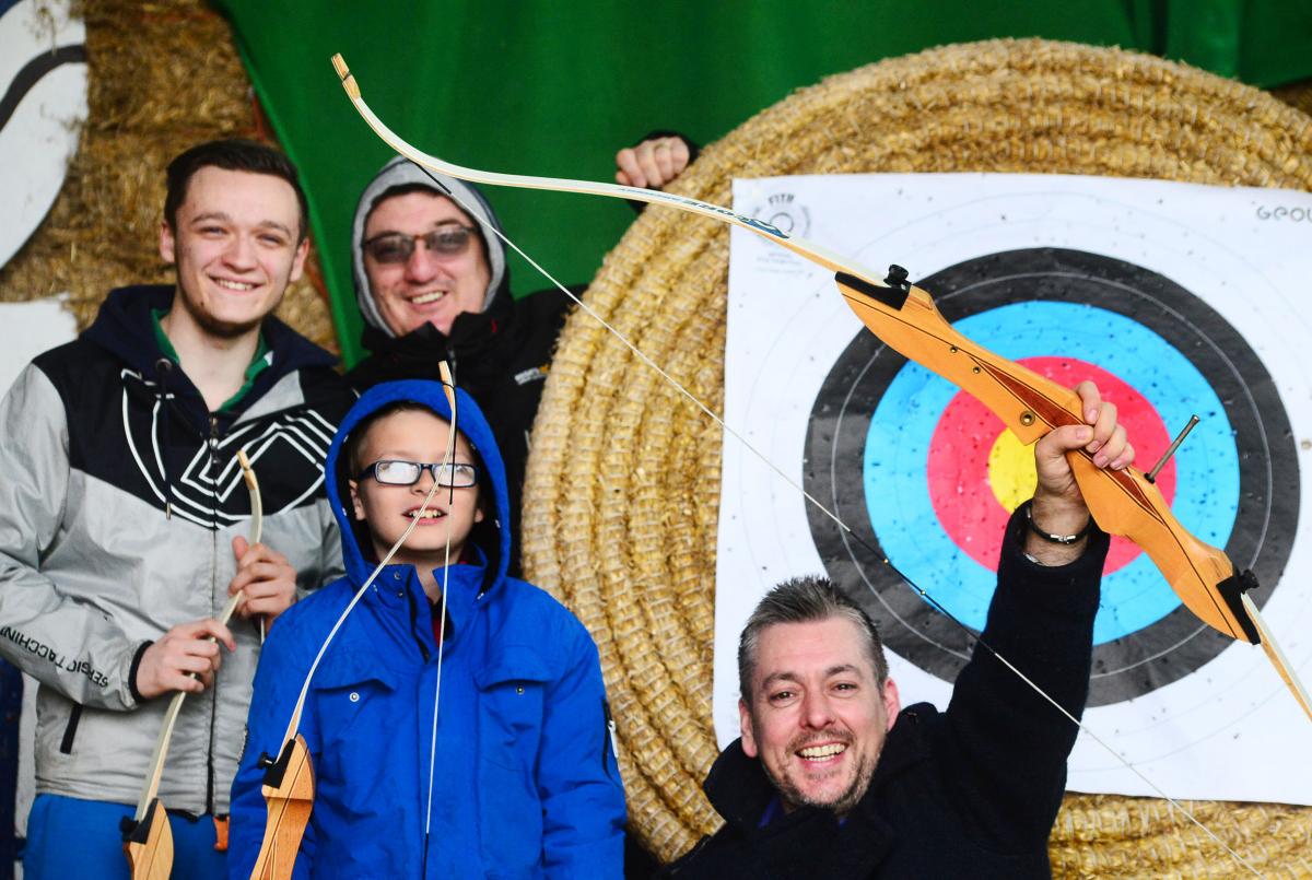 GOOD SHOT: Tyler Paul, Darren Paul, Stevie Woods and Dudley Berry celebrate a near bullseye on the archery range