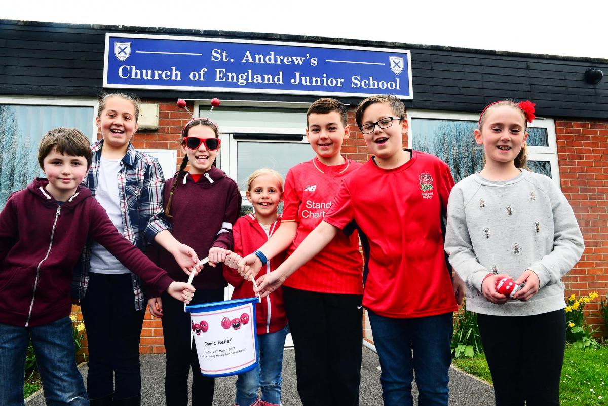 FUNDRAISING: Pupils from St Andrew’s Junior School dressed in red get ready to collect donations for Comic Relief