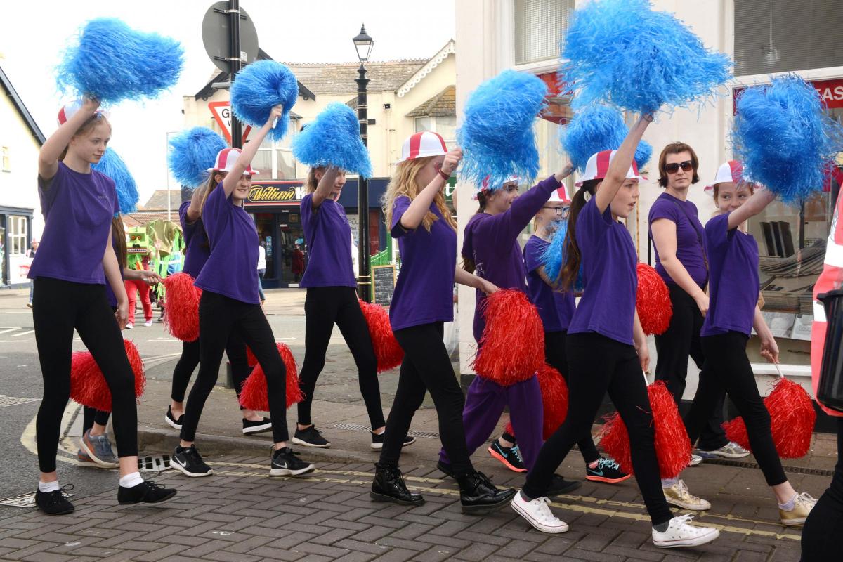CHEERING: Young dancers from Dance Fit Academy parade with pom poms
