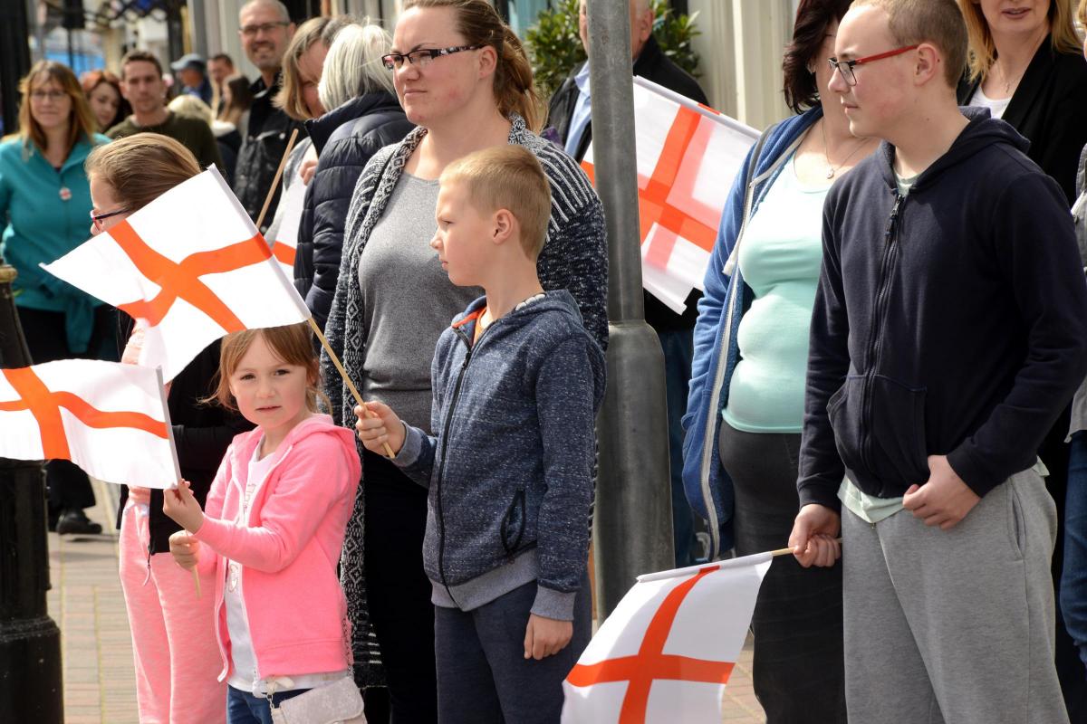 PATRIOTIC PARADE: Visitors wave the England flag during the special event