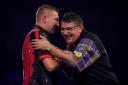 EXIT: Gary Anderson (right) congratulates Nathan Aspinall on his victory at the PDC World Championship at Alexandra Palace, London. Pic: PA Wire