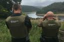 LOOKOUT: Environment Agency officers patrolling a river bank during the close season which forbids catching fish like barbel and chub