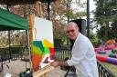 COLOUR: Artist Phil Ironside paints on the bandstand in Priory Park for Malvern Water and Well Dressing Festival