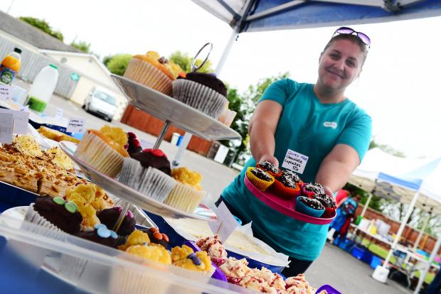 Burnham and Highbridge Weekly News: The North Somerset branch's deputy manager Katy Darelli with homemade cakes at the pop-up shop event. Picture: Steve Richardson